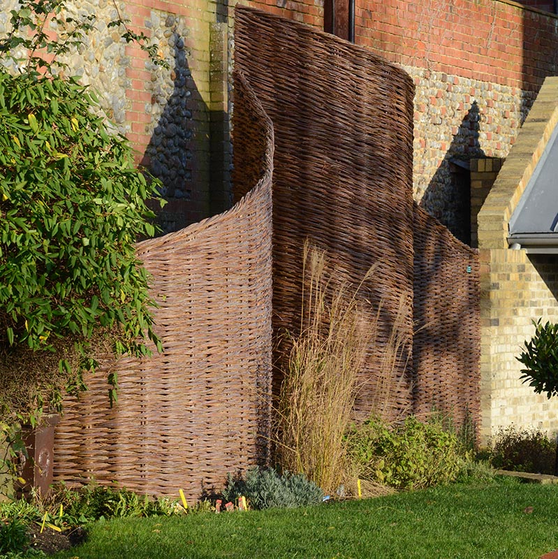 Landscape design consultation with curved willow fence in background